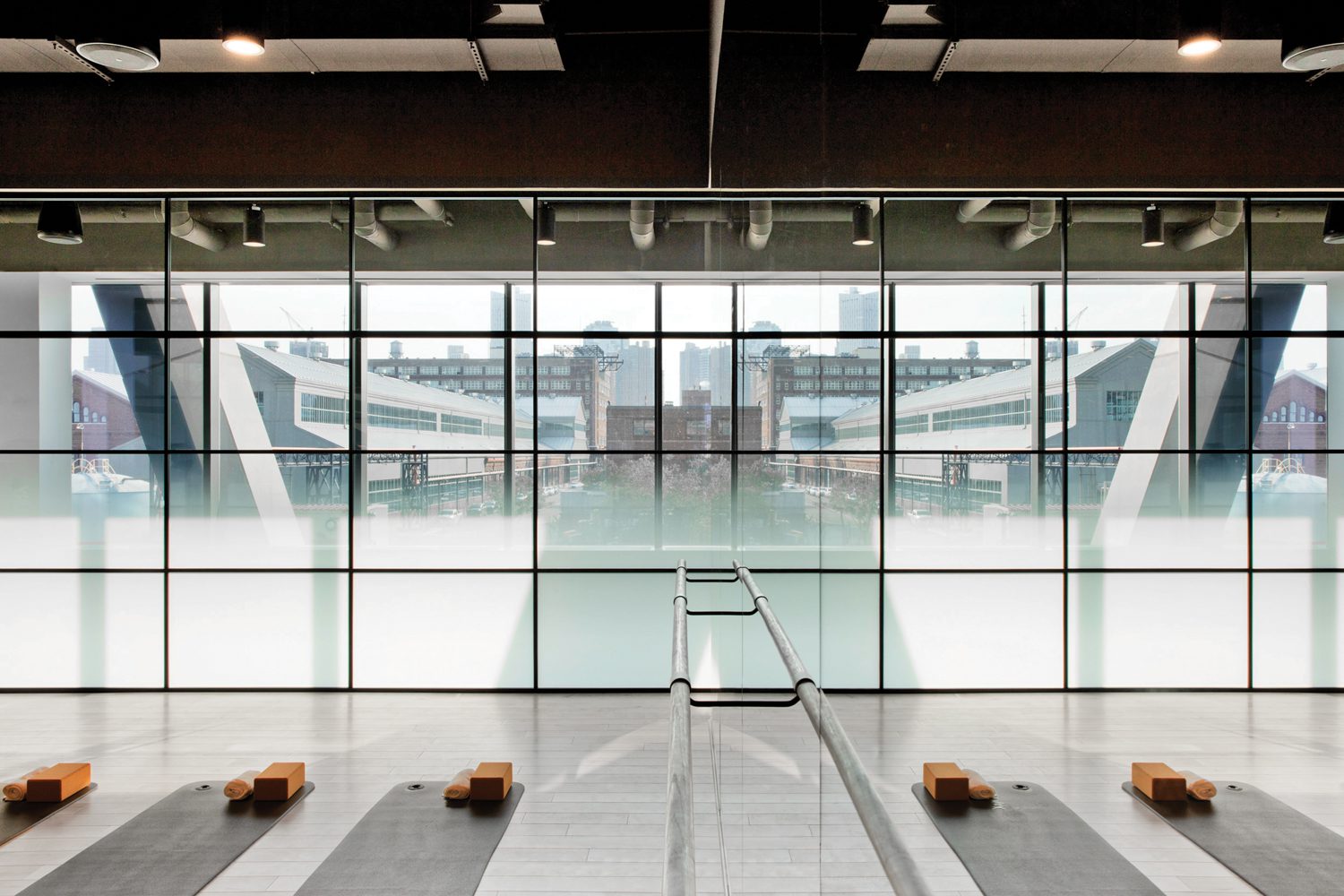 玻璃封闭健身房有白橡树地板反向底部:Bower工作室镜像SoudaSass表和PaulSmith内置板板装提供会议室