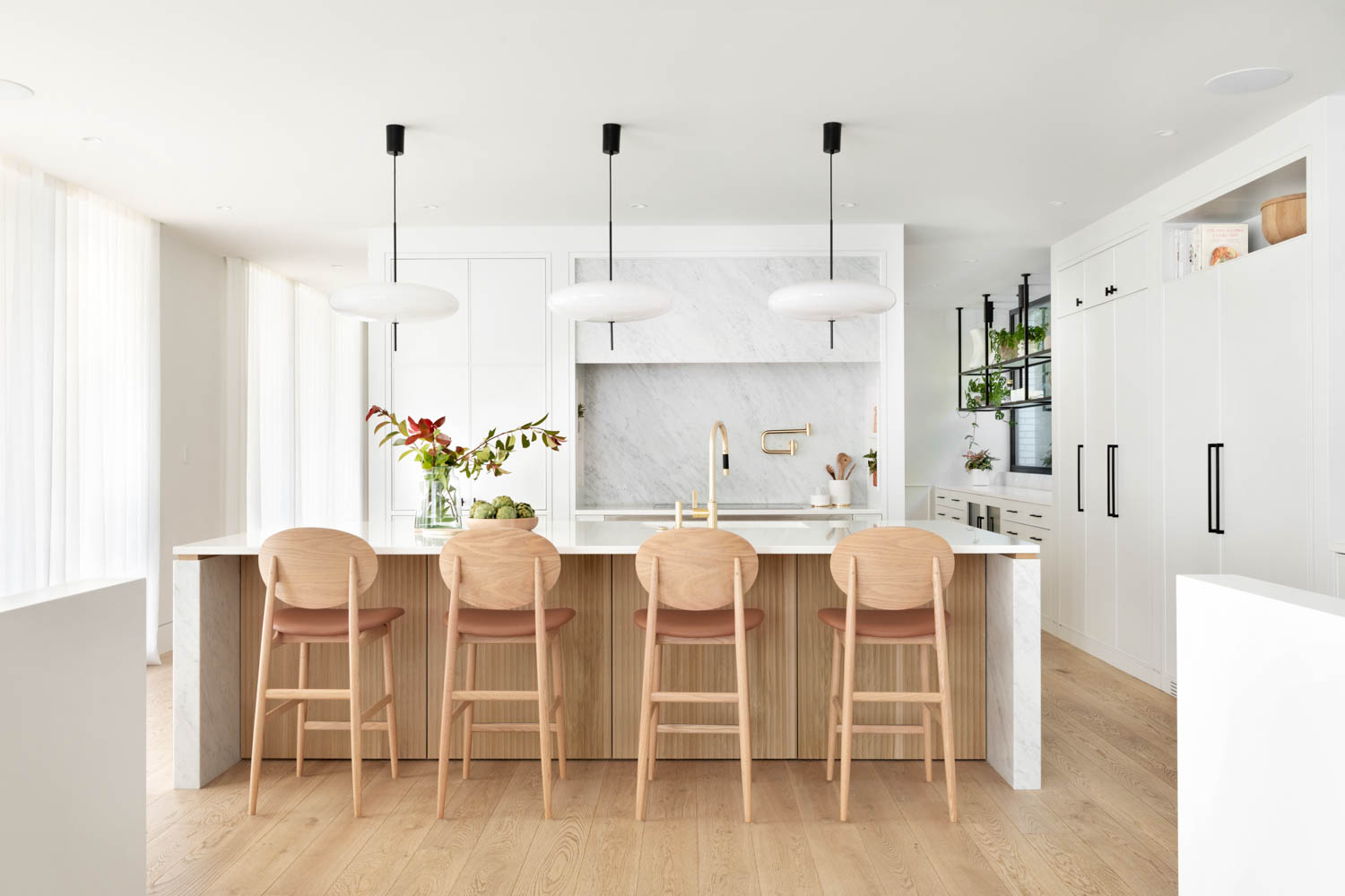 In the kitchen, the Outline counter stools by Norm Architects are from Hem Interiors and the Model 2065 pendants are by Astep.