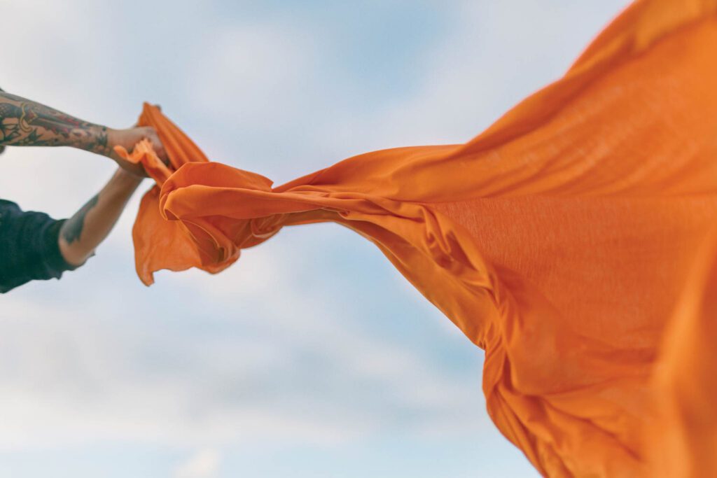 手握橙织物百分百 Infinna