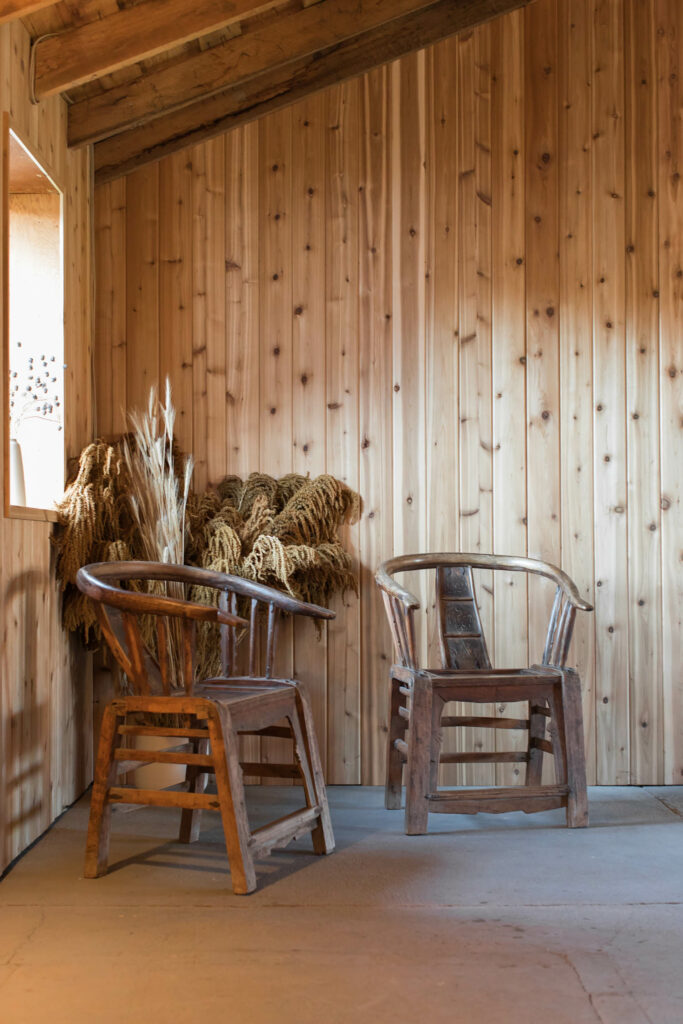 木制的椅子和干花活跃这个谷仓的角落