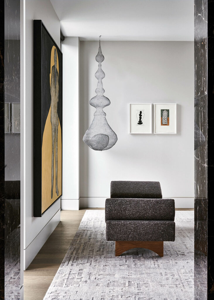 a KatherineHogan电线雕刻挂在白床上方